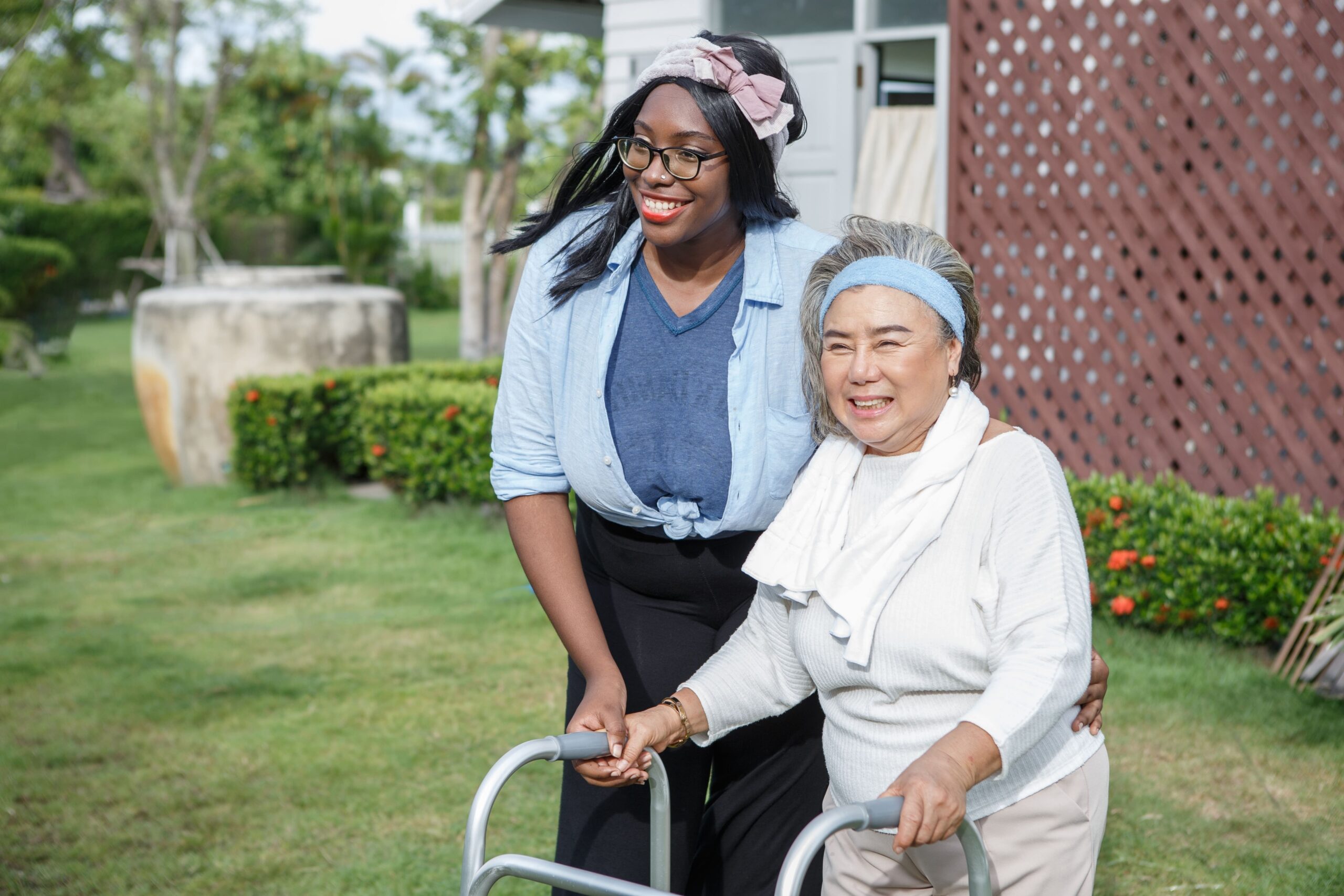 in-home carers and elderly woman helping