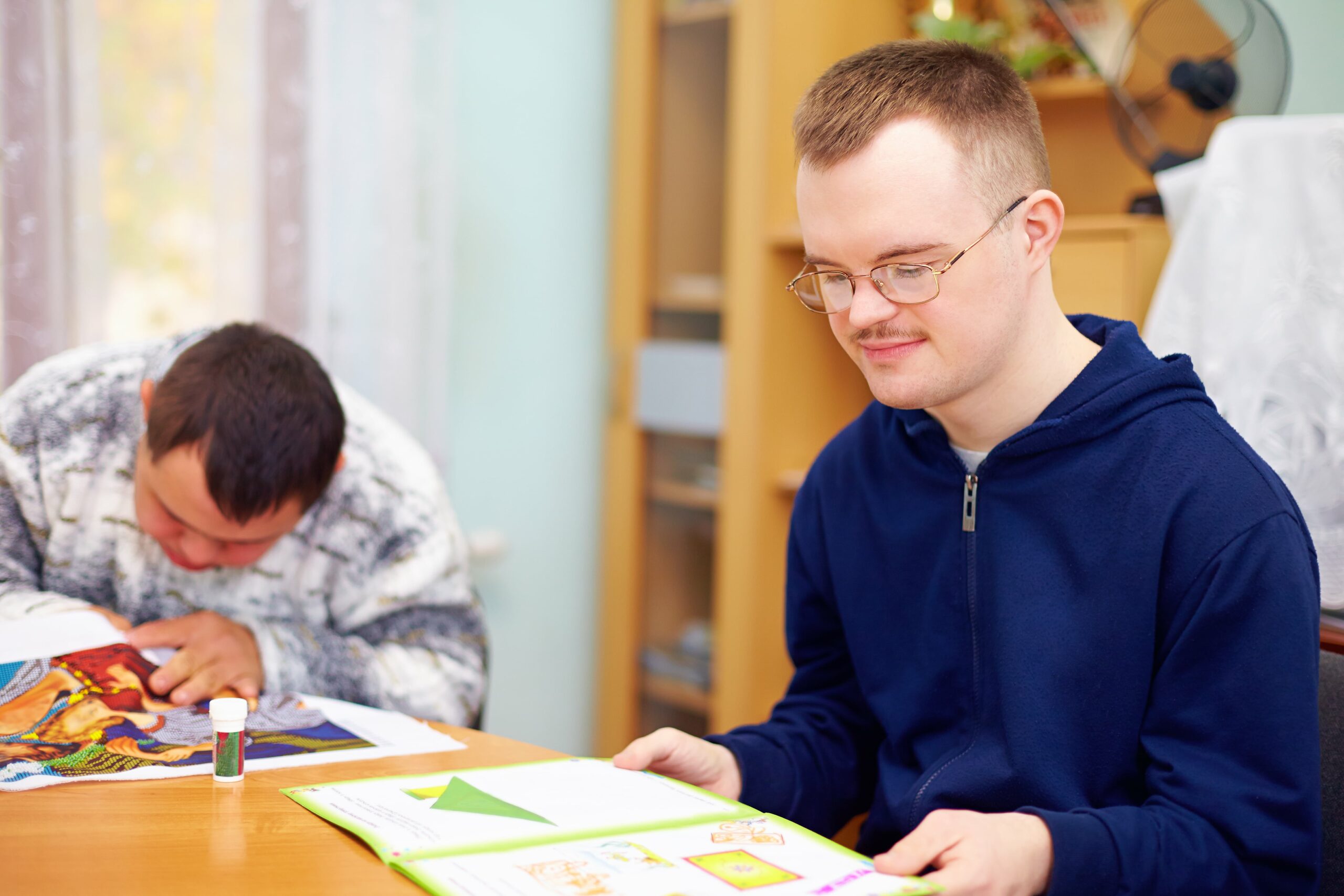 man with learning disability reading a book